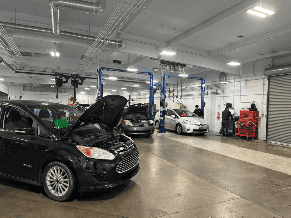 Image showcasing Ford C-Max and Toyota Prius hybrid vehicles at Earthling Automotive service