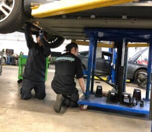 Earthling Automotive Techs installing Tesla 12v battery