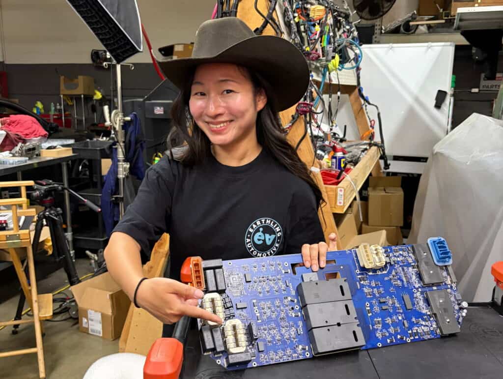 Grace holding a Tesla Cybertruck Power Conversion System PCS board